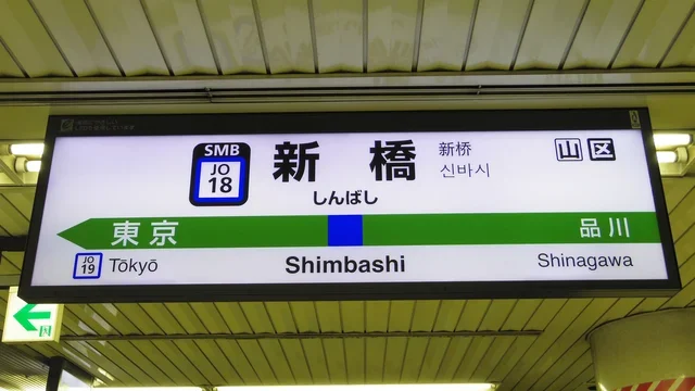 JR新橋駅の駅名標。「新橋 しんばし Shimbashi」の文字と、隣の駅として東京・品川が示されている